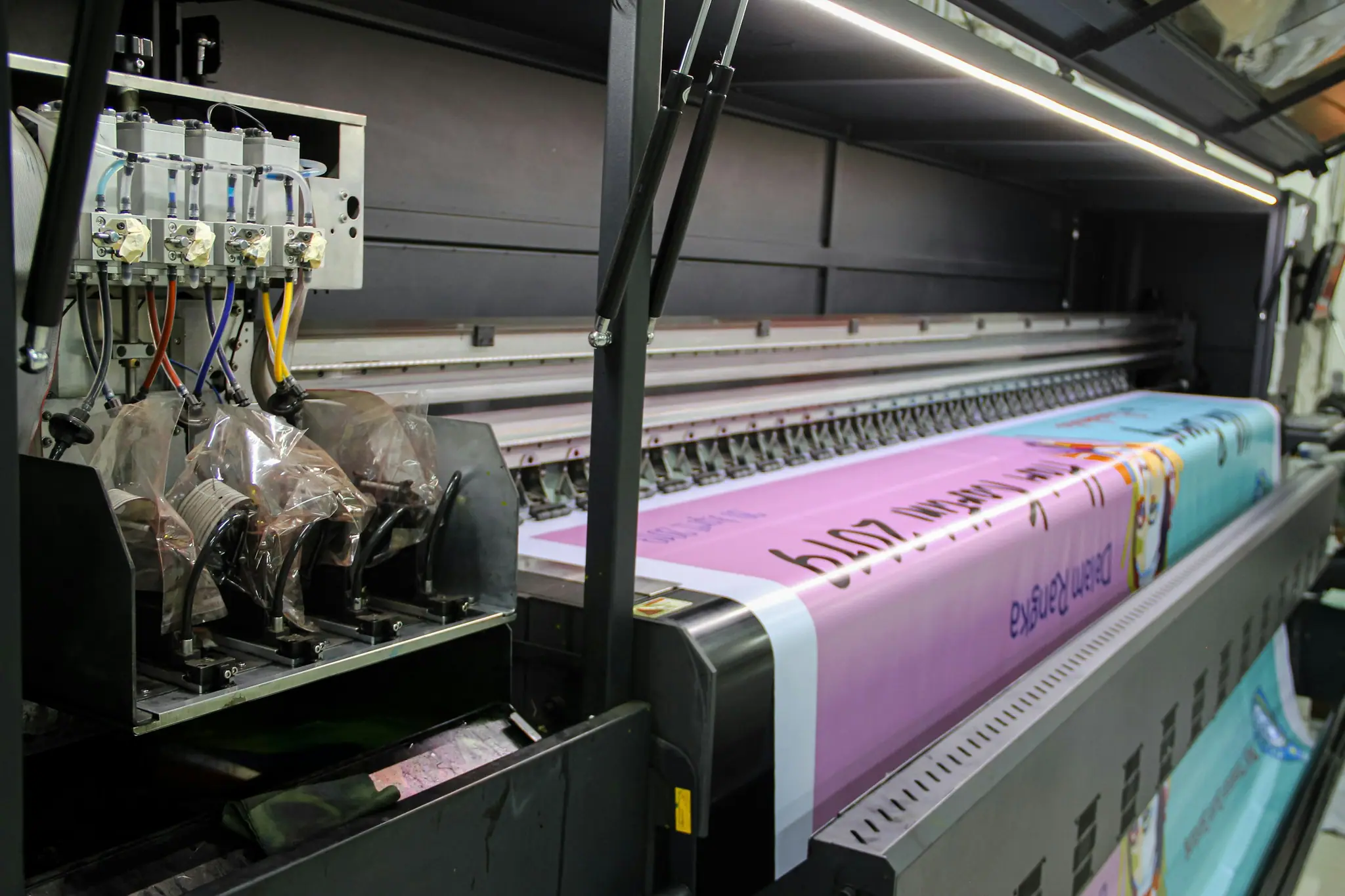 Wide-format printer producing a large magenta banner